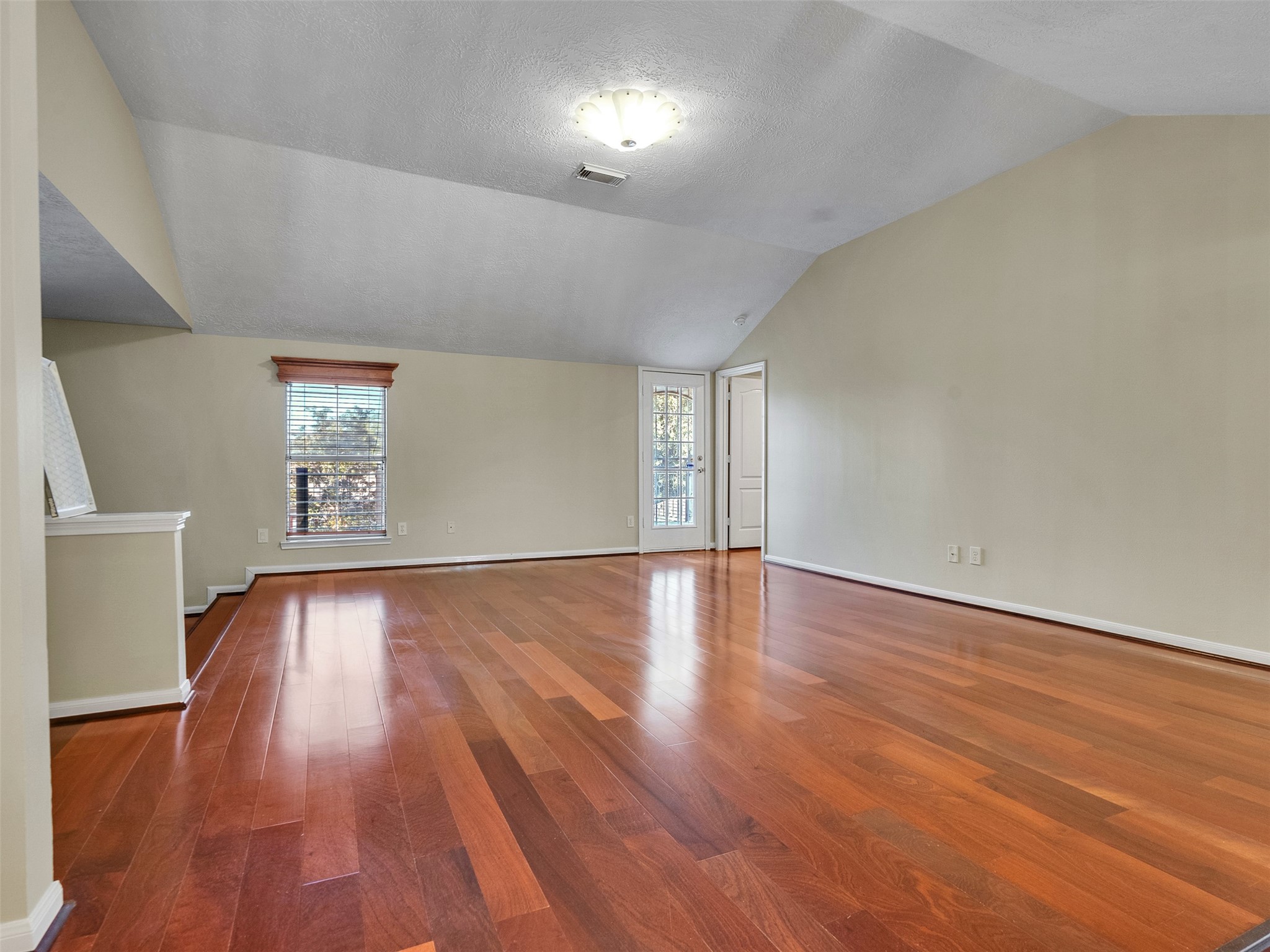 4414 Santee Drive Baytown, TX 77521 - Photo 25 of 50 a view of an empty room with wooden floor and a window