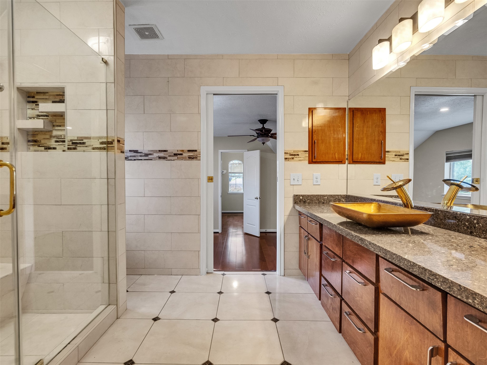 4414 Santee Drive Baytown, TX 77521 - Photo 34 of 50 a bathroom with a granite countertop sink and a mirror