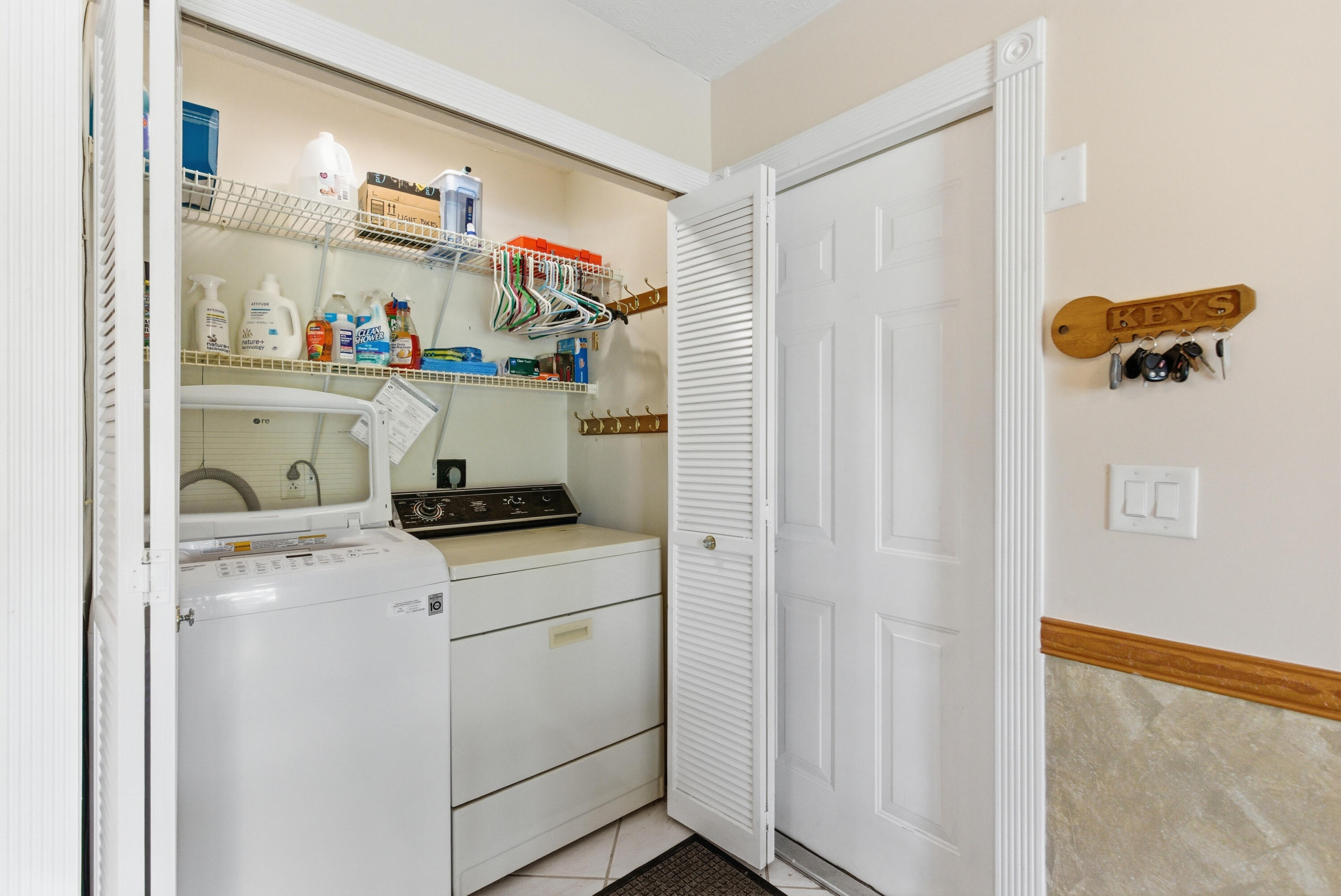 5151 Southeast Burning Tree Circle Stuart, FL 34997 - Photo 38 of 74 a kitchen with white cabinets and white appliances