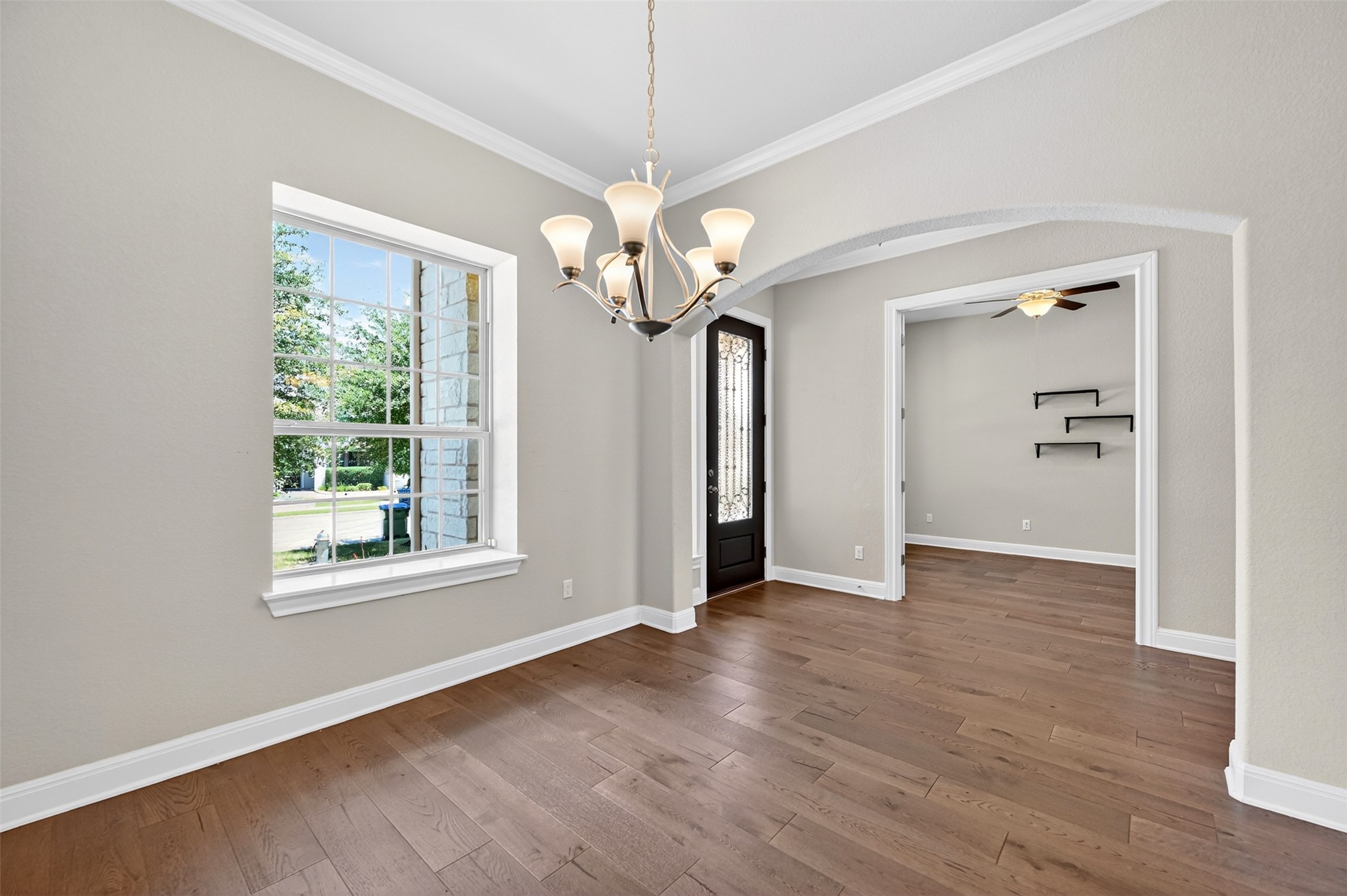 1201 Positano Pass Leander, TX 78641 - Photo 5 of 40 Spacious room featuring wood-finish flooring, an elegant chandelier, and crown molding