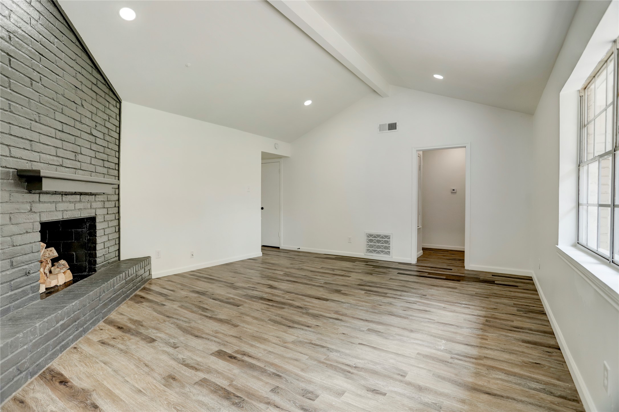 14035 Myrtlea Drive Houston, TX 77079 - Photo 37 of 38 The floor plan enjoys a coveted vaulted ceiling in the living room. Recessed lighting was added as well.