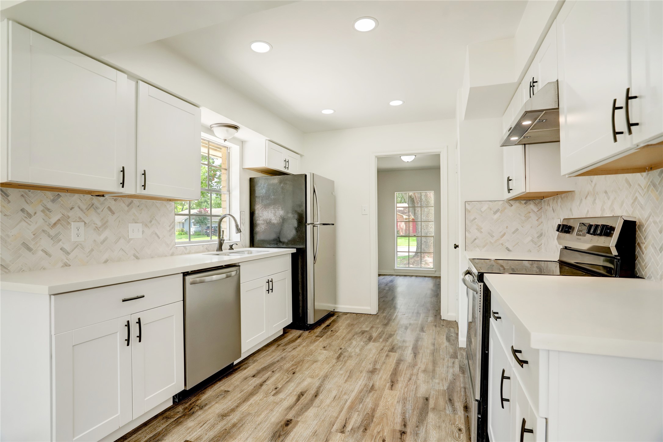 14035 Myrtlea Drive Houston, TX 77079 - Photo 8 of 38 Beautifully updated kitchen with new cabinets, countertops, backsplash, and appliances.