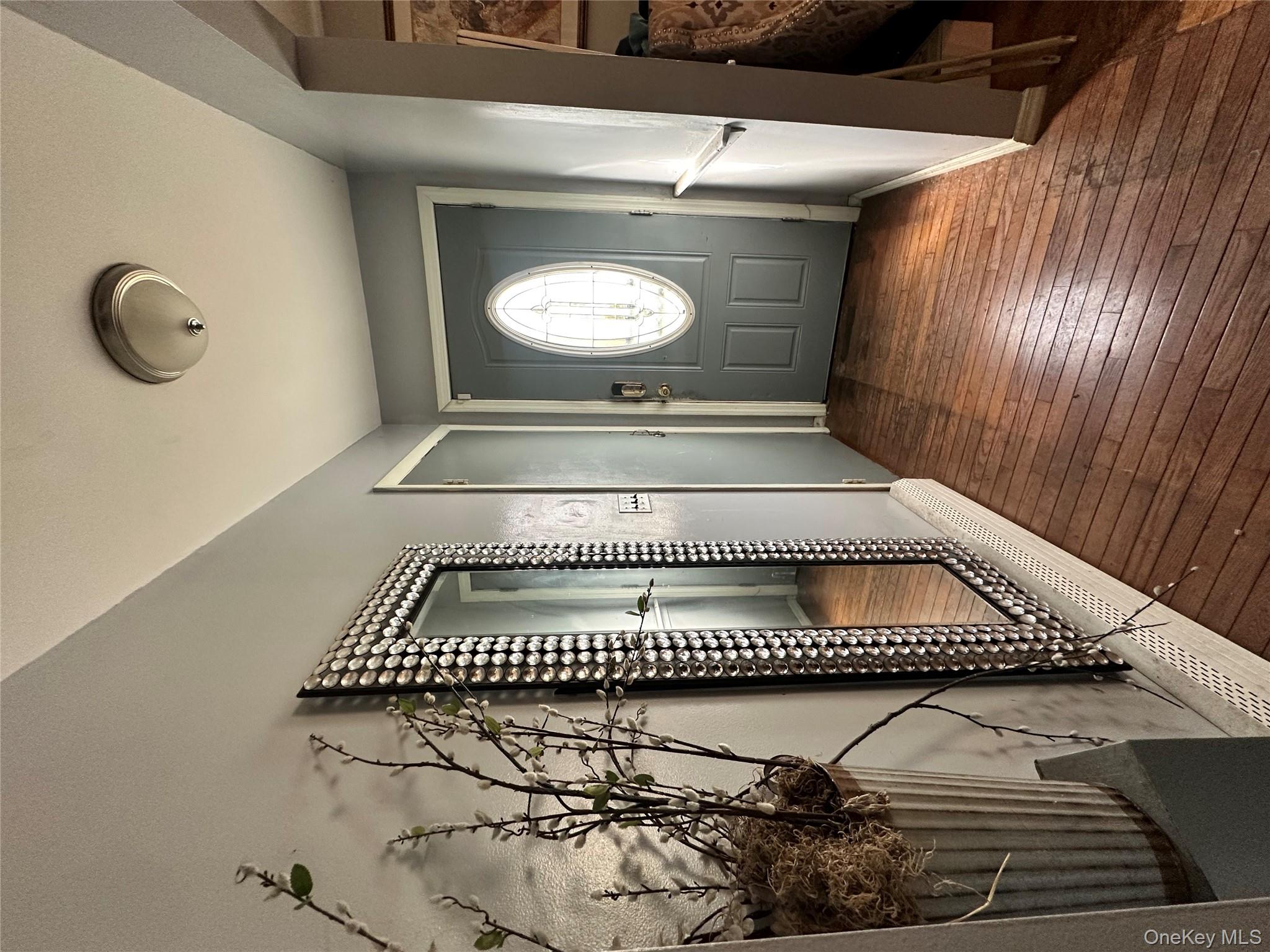 16 Spring Street Roosevelt, NY 11575 - Photo 19 of 19 an empty room with wooden floor mirror and windows