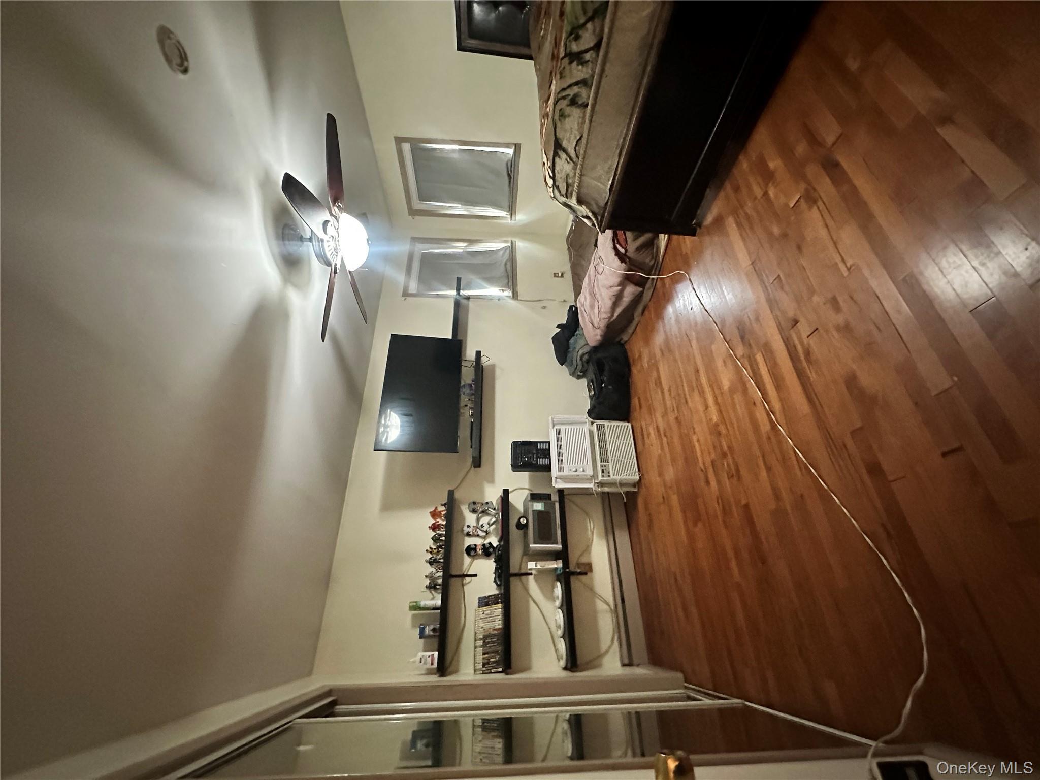 16 Spring Street Roosevelt, NY 11575 - Photo 6 of 19 a living room with furniture and a flat screen tv