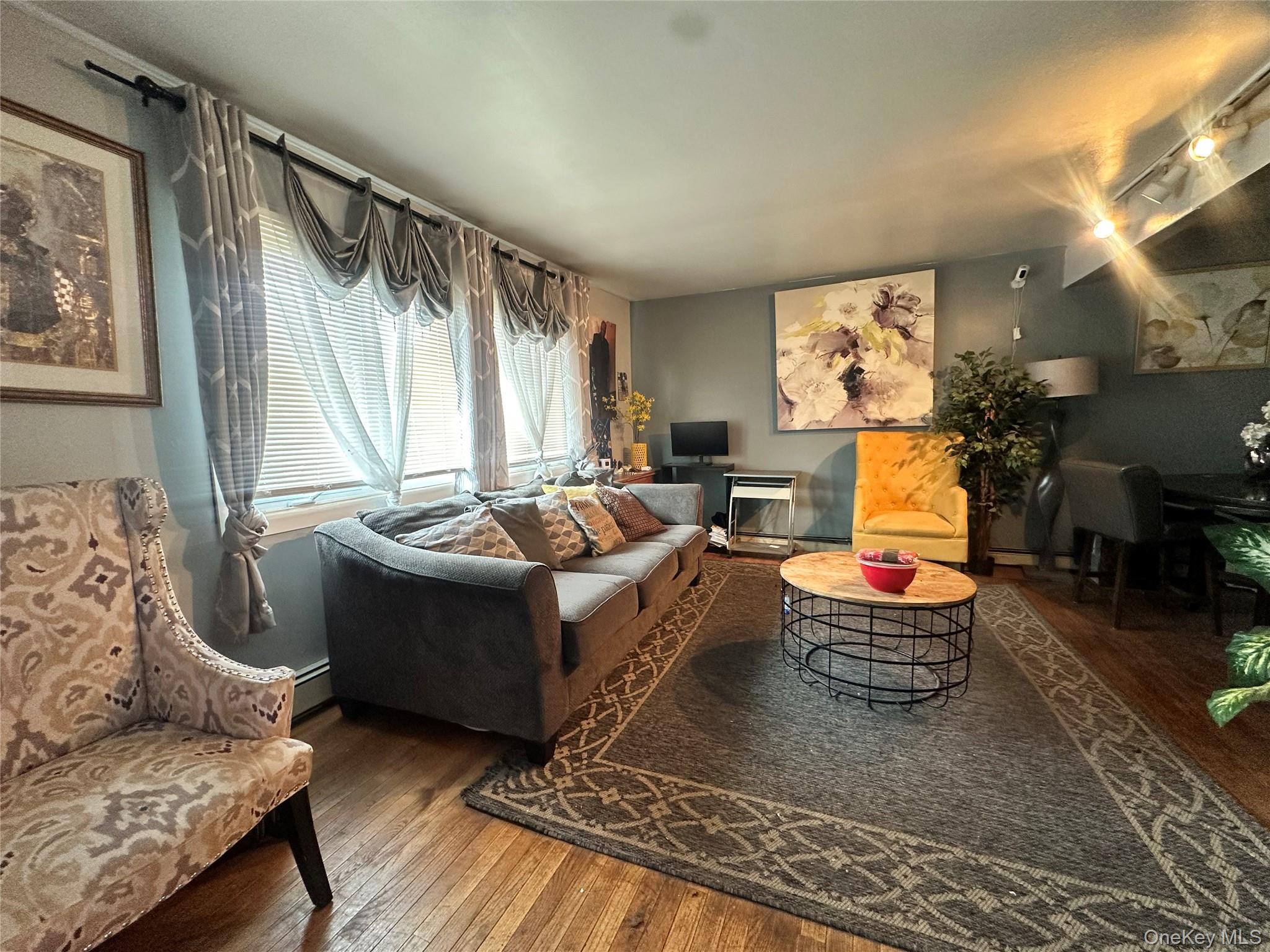 16 Spring Street Roosevelt, NY 11575 - Photo 10 of 19 a living room with furniture and a large window