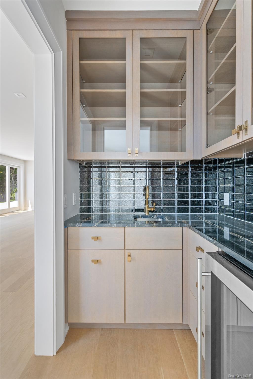 42 Mamaroneck Road Scarsdale, NY 10583 - Photo 10 of 47 The custom wet bar adjoining the first-floor office and family room offers elegant built-in cabinetry and the perfect space for coffee, cocktails, or entertaining clients and guests.
