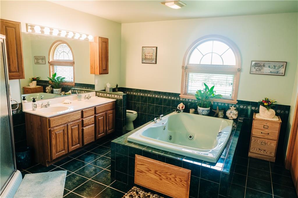 329 Breakiron Road Connellsville, PA 15425 - Photo 14 of 19 a bathroom with a sink mirror and a bathtub