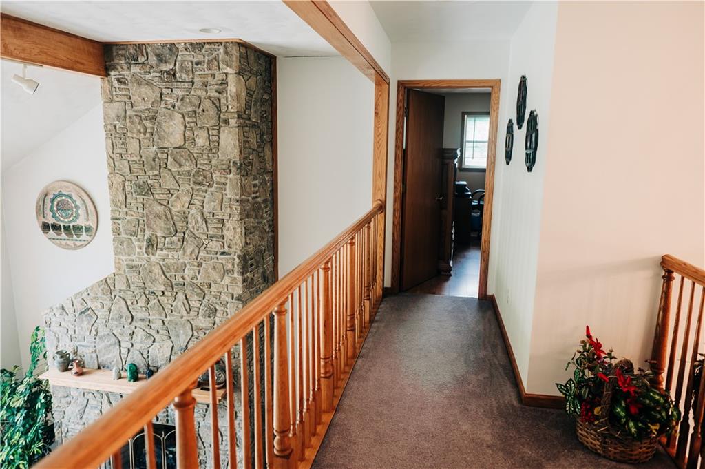 329 Breakiron Road Connellsville, PA 15425 - Photo 18 of 19 a view of a hallway with wooden floor and stairs