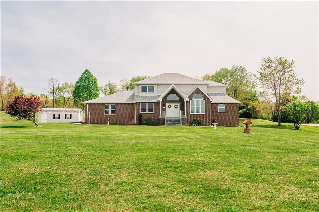 329 Breakiron Road Connellsville, PA 15425 - Photo 5 of 19 a front view of a house with a yard and trees