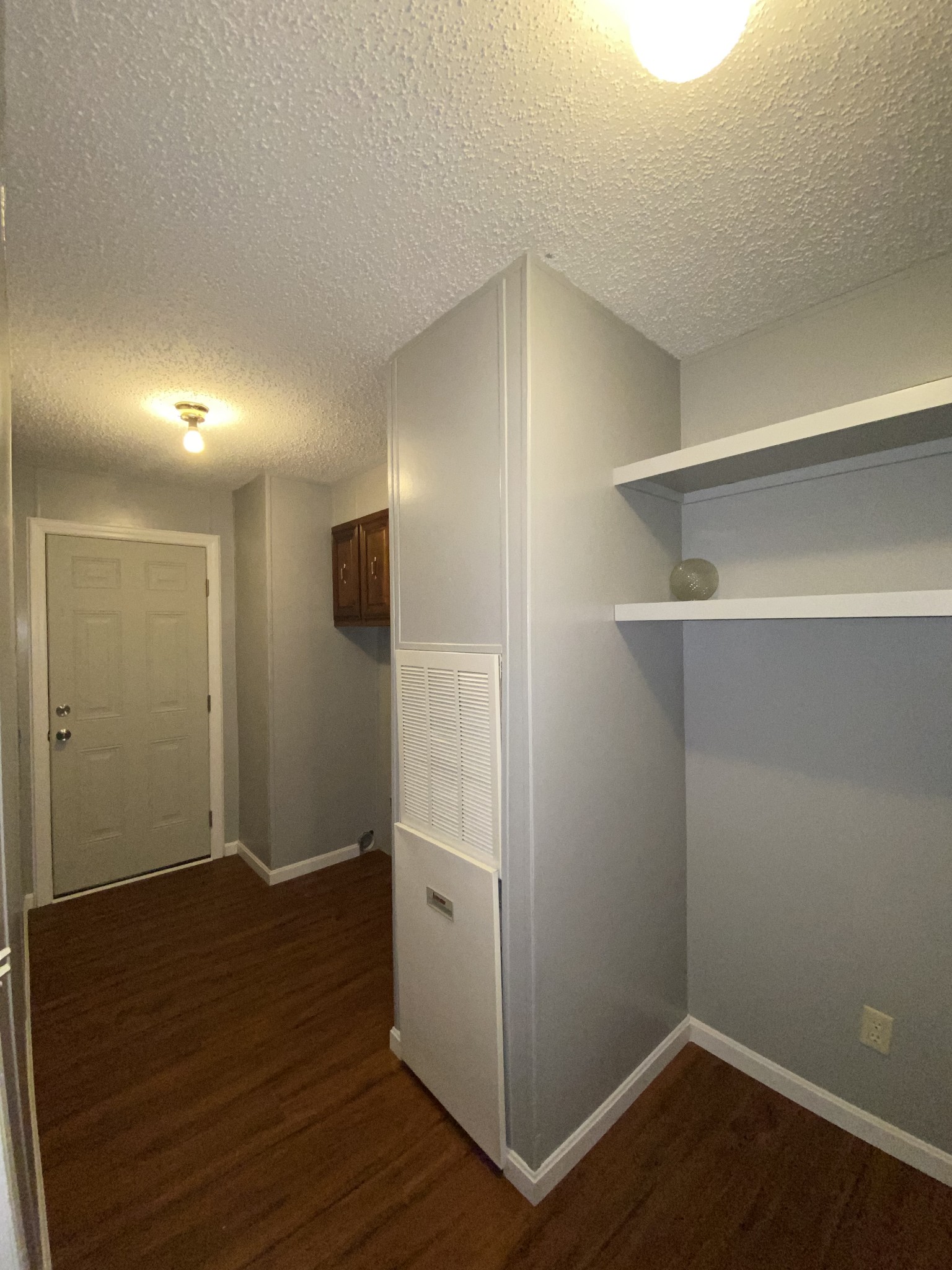 7106 Lake Road Northwest Fairview, TN 37062 - Photo 11 of 20 The Laundry Room is very spacious measuring 6x13. Cabinets over washer & dryer area and shelving for extra storage. Doorway leads to the covered back deck.