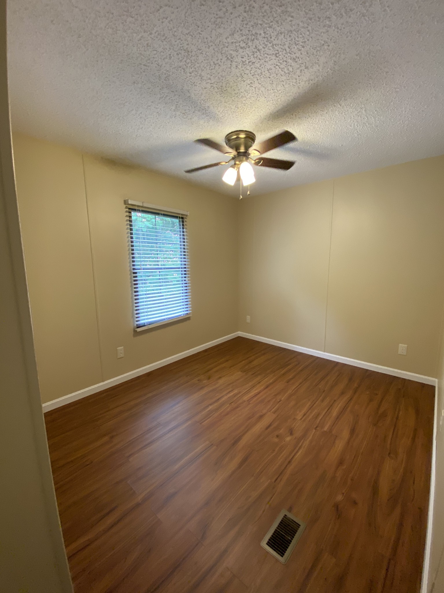 7106 Lake Road Northwest Fairview, TN 37062 - Photo 17 of 20 Bedroom 2 is located just off the den. It measures 9x11 - has ceiling fan and laminate flooring