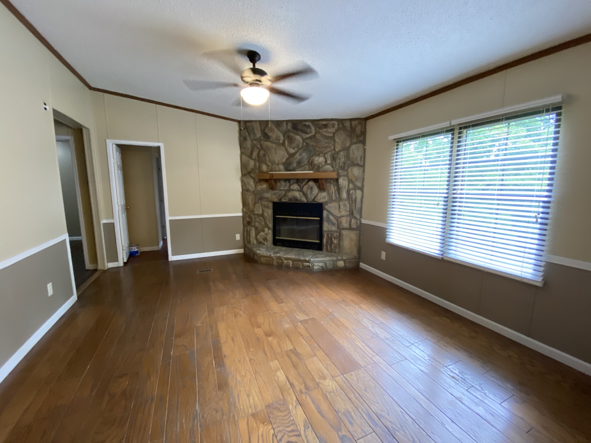 7106 Lake Road Northwest Fairview, TN 37062 - Photo 7 of 20 The Den is located on the back side of the home, has hardwood floors and a Beautiful Wood Burning Fireplace. 3 Bedrooms and 1 Full Bath is located on this side of the house.