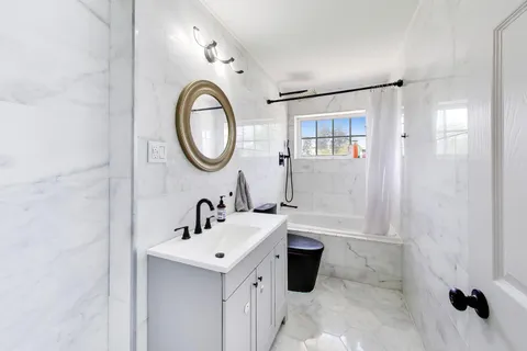 a bathroom with a sink a mirror and a shower