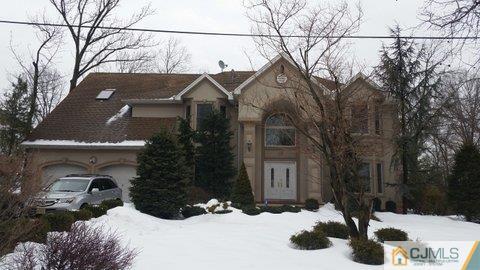 16 Parker Road Edison, NJ 08820 - Photo 2 of 25 a view of a house with a yard covered in snow