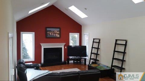 16 Parker Road Edison, NJ 08820 - Photo 11 of 25 a bedroom with furniture and a fireplace