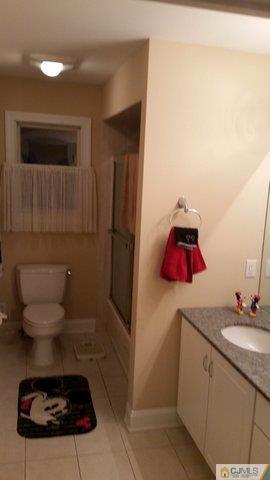 16 Parker Road Edison, NJ 08820 - Photo 18 of 25 a bathroom with a toilet and a sink