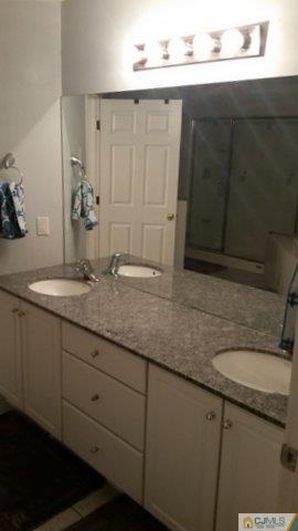 16 Parker Road Edison, NJ 08820 - Photo 19 of 25 a bathroom with a sink and a mirror
