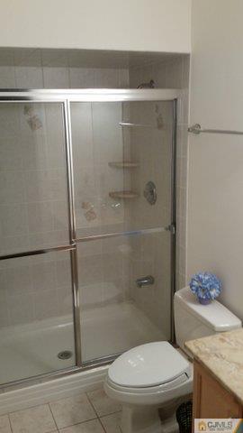 16 Parker Road Edison, NJ 08820 - Photo 20 of 25 a bathroom with a shower and a toilet