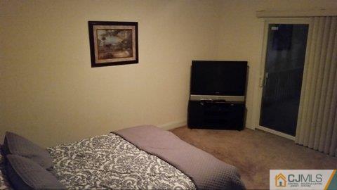 16 Parker Road Edison, NJ 08820 - Photo 22 of 25 a bedroom with a bed and a tv