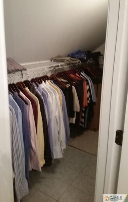 16 Parker Road Edison, NJ 08820 - Photo 23 of 25 a view of walk in closet with clothes and shoes