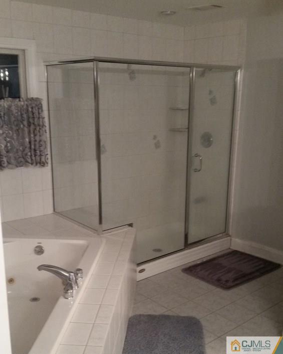 16 Parker Road Edison, NJ 08820 - Photo 24 of 25 a bathroom with a bathtub and shower