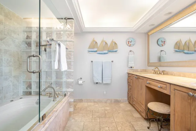 a bathroom with a granite countertop sink a toilet and bathtub