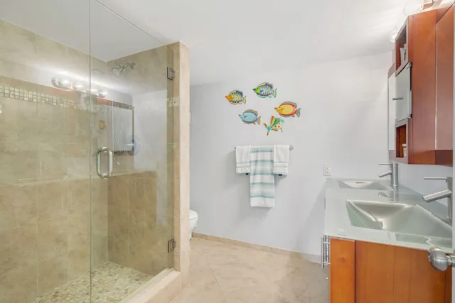 a bathroom with a sink a vanity and a shower