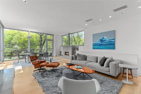 a kitchen with stainless steel appliances kitchen island granite countertop a table chairs sink and cabinets