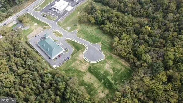 an aerial view of a residential houses with outdoor space