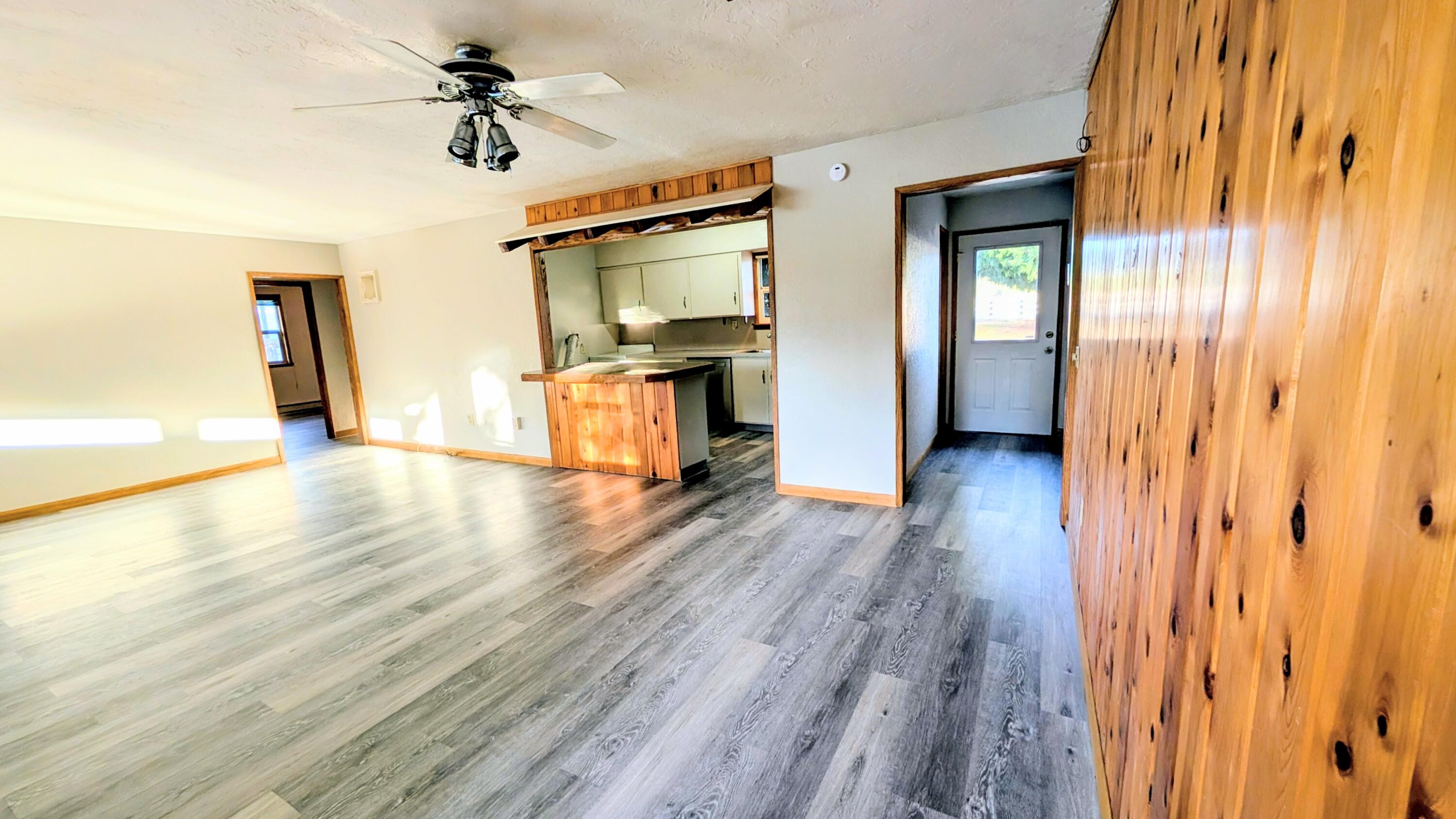 32550 Rivers Drive Chiloquin, OR 97624 - Photo 8 of 24 a view of a livingroom with wooden floor and a ceiling fan