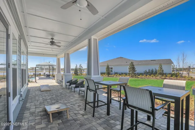 a view of a livingroom with furniture sitting space and floor to ceiling window
