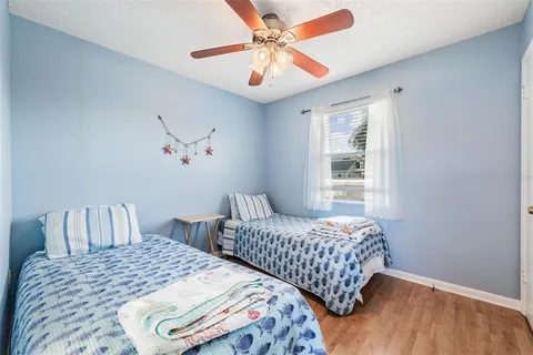 a bedroom with two beds and a window