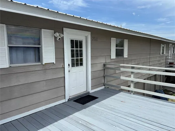 a view of a house with a door and wooden floor
