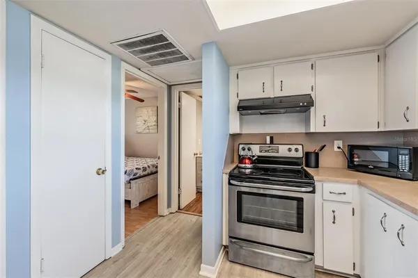 a kitchen with cabinets and steel appliances