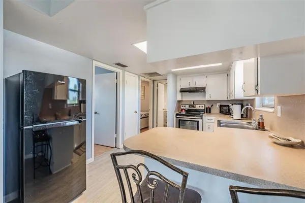 a kitchen with stainless steel appliances a refrigerator and a stove top oven