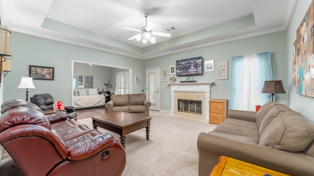 4420 Reese Road, Unit 1D Columbus, GA 31907 - Photo 6 of 17 a living room with furniture a fireplace and a chandelier