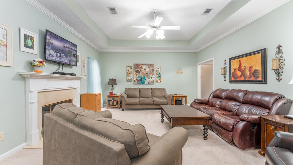 4420 Reese Road, Unit 1D Columbus, GA 31907 - Photo 7 of 17 a living room with furniture a fireplace and a painting
