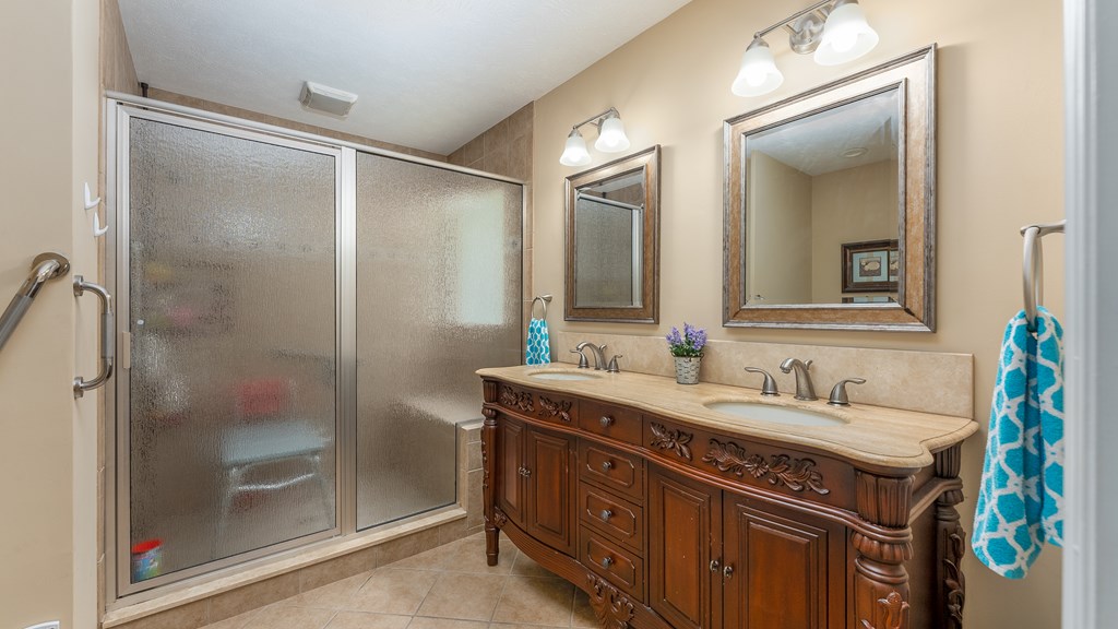 4420 Reese Road, Unit 1D Columbus, GA 31907 - Photo 10 of 17 a bathroom with a double vanity sink mirror and shower