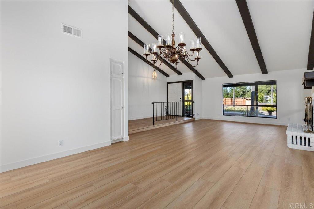112 Palmas Norte Fallbrook, CA 92028 - Photo 14 of 74 a view of an empty room with wooden floor and a window