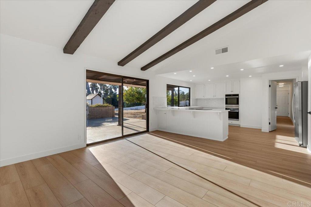 112 Palmas Norte Fallbrook, CA 92028 - Photo 20 of 74 a view of an empty room with wooden floor and a window