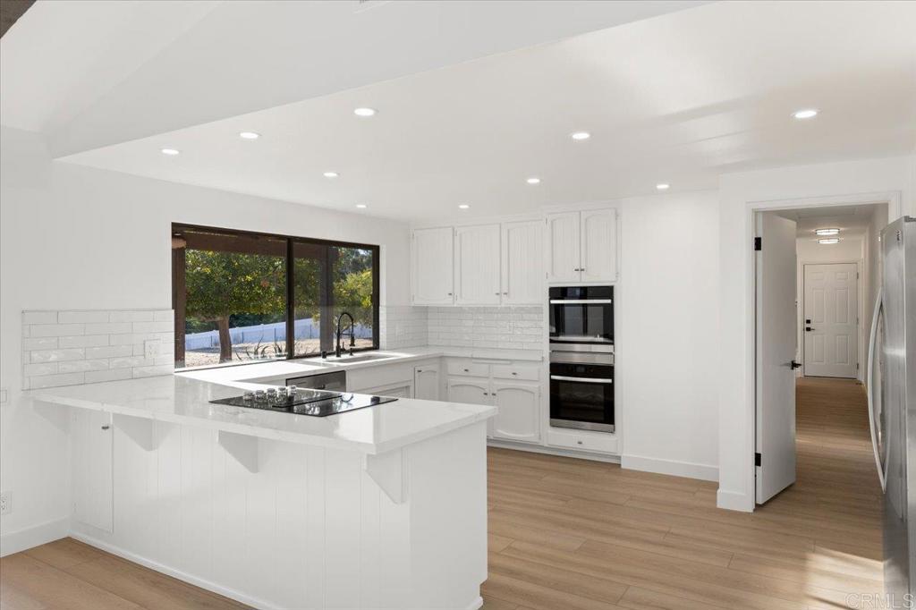 112 Palmas Norte Fallbrook, CA 92028 - Photo 25 of 74 a kitchen with stainless steel appliances granite countertop a stove and a refrigerator