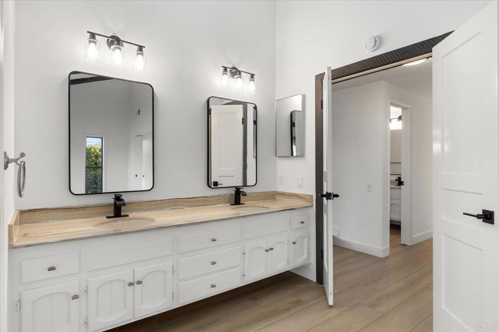 112 Palmas Norte Fallbrook, CA 92028 - Photo 34 of 74 a bathroom with double vanity sinks and a mirror