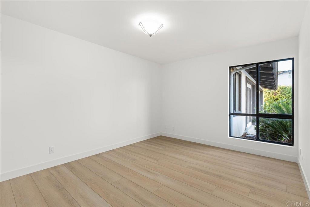 112 Palmas Norte Fallbrook, CA 92028 - Photo 37 of 74 an empty room with wooden floor and windows