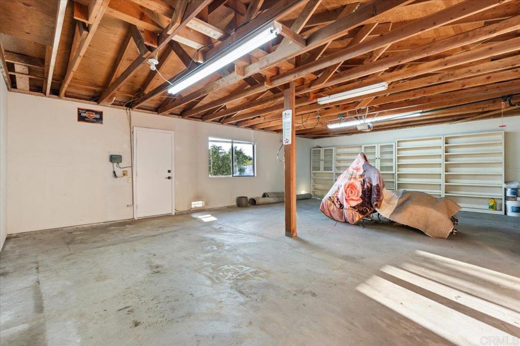 112 Palmas Norte Fallbrook, CA 92028 - Photo 62 of 74 a view of a garage with a table and a chair