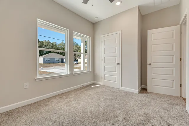 an empty room with windows and closet