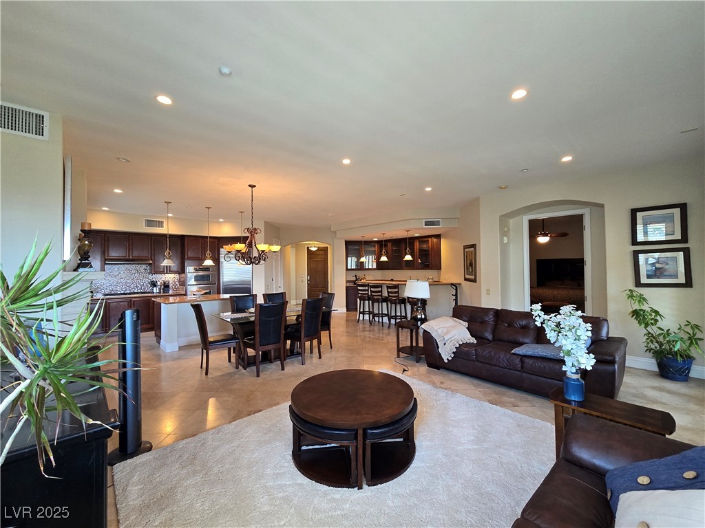 20 Via Mantova, Unit 202 Henderson, NV 89011 - Photo 11 of 60 Living area with arched walkways, light tile patterned floors, recessed lighting, and a chandelier