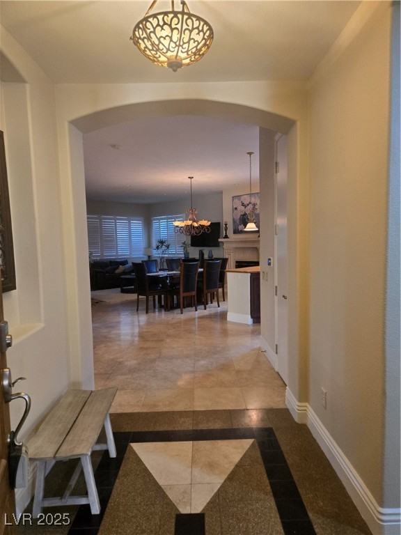 20 Via Mantova, Unit 202 Henderson, NV 89011 - Photo 25 of 60 Hallway with inlaid floor details, arched walkways, and a chandelier