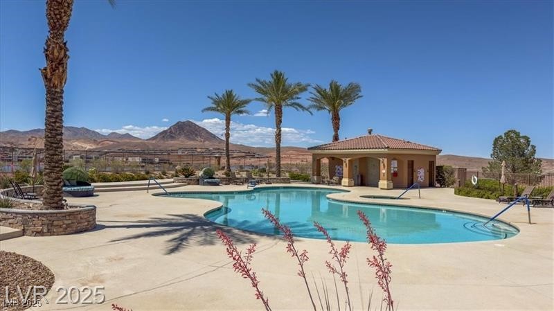 20 Via Mantova, Unit 202 Henderson, NV 89011 - Photo 58 of 60 Community pool with a patio area and a mountain view