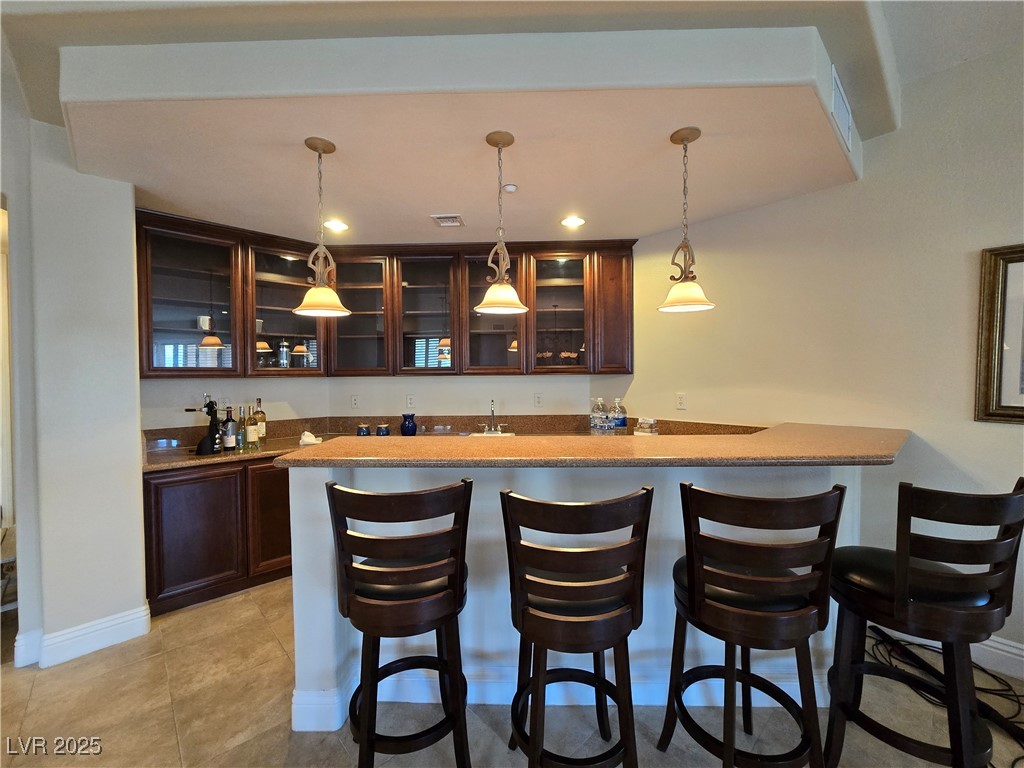 20 Via Mantova, Unit 202 Henderson, NV 89011 - Photo 9 of 60 Indoor wet bar with hanging light fixtures, light tile patterned floors, and recessed lighting