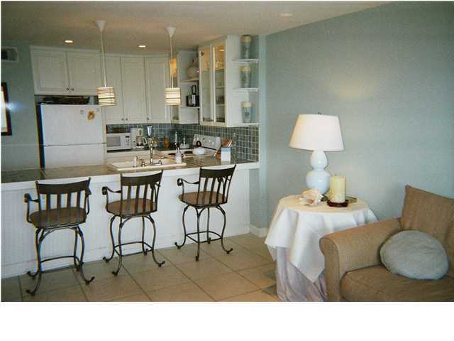 8294 Hwy Inlet Beach, Unit 7 30A Inlet Beach, FL 32461 - Photo 4 of 8 a kitchen with a table chairs and a living room view